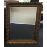 A gilt framed mirror with bevelled edge. Approx. 9