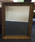 A gilt framed mirror with bevelled edge. Approx. 9