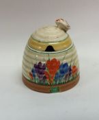 A Clarice Cliff 'Crocus' pattern honey pot with li