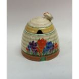 A Clarice Cliff 'Crocus' pattern honey pot with li