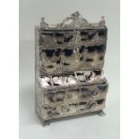 An unusual miniature silver bureau bookcase profus