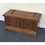 A small oak carved hinged top trunk. Est. £25 - £3