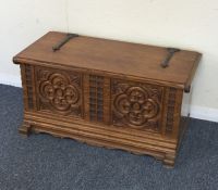 A small oak carved hinged top trunk. Est. £25 - £3