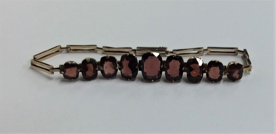 A gold mounted garnet bracelet with concealed clas