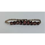 A gold mounted garnet bracelet with concealed clas