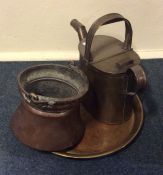 A brass watering can together with a copper basket