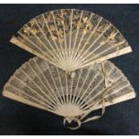 A group of two carved ivory fans. Est. £30 - £50