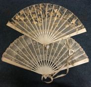 A group of two carved ivory fans. Est. £30 - £50