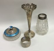 A heavy silver spill vase together with napkin rin