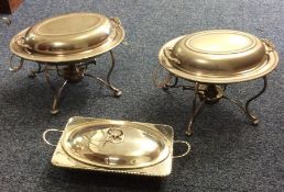 A pair of silver plated entrée dishes on stands to