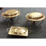 A pair of silver plated entrée dishes on stands to