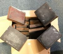A box containing miniature printer's plates of var