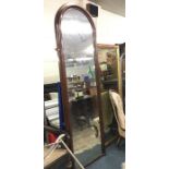 A tall mahogany framed mirror with oval top. Appro