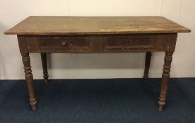 A Victorian stripped pine two drawer table. Est. £