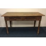 A Victorian stripped pine two drawer table. Est. £