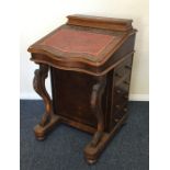A Victorian mahogany hinged top Davenport with fit