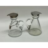 A pair of silver mounted glass whisky tots. Est. £