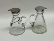 A pair of silver mounted glass whisky tots. Est. £