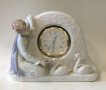 LLADRO: A cased clock decorated with swans and fig