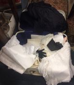 A suitcase containing linen, placemats etc. Est. £