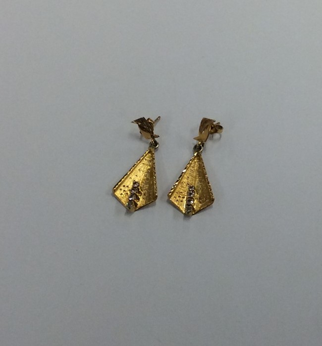 A pair of 18 carat four stone earrings. Approx. 5
