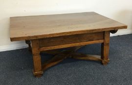 A large oak occasional table with stretcher base.