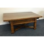 A large oak occasional table with stretcher base.