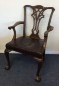 An Edwardian carver chair with ball and claw feet.