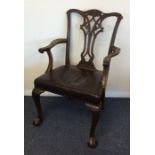 An Edwardian carver chair with ball and claw feet.