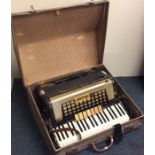 A cased accordion by Scandalli. Est. £30 - £50.