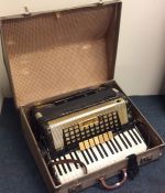 A cased accordion by Scandalli. Est. £30 - £50.
