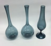 A pair of pale blue baluster shaped glass vases to