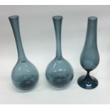A pair of pale blue baluster shaped glass vases to