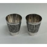 A pair of heavy Indian silver spirit tots of taper