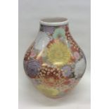 A massive Chinese vase decorated with bright flowe