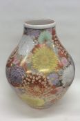 A massive Chinese vase decorated with bright flowe