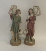 A pair of Royal Dux figures of ladies carrying urn