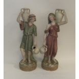 A pair of Royal Dux figures of ladies carrying urn