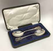 A cased pair of Edwardian silver pierced spoons. S