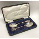 A cased pair of Edwardian silver pierced spoons. S