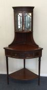 An attractive Edwardian mahogany corner cabinet wi