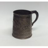 A Georgian silver pint tankard embossed with flowe