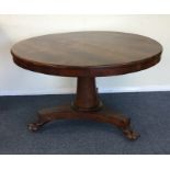 A circular rosewood loo table on tapering base. Es