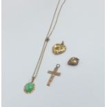 A small gold cross together with a locket, pendant