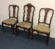 A pair of Dutch marquetry hall chairs of typical d