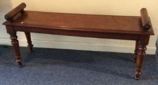 A mahogany window seat on tapering legs. Est. £70