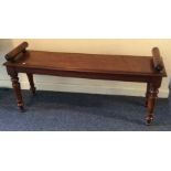 A mahogany window seat on tapering legs. Est. £70