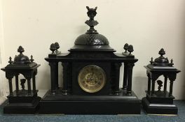 A massive slate clock garniture with Corinthian co