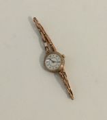 A lady's 9 carat wrist watch on expanding strap. A