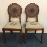 A pair of cane back Edwardian chairs with tapestry